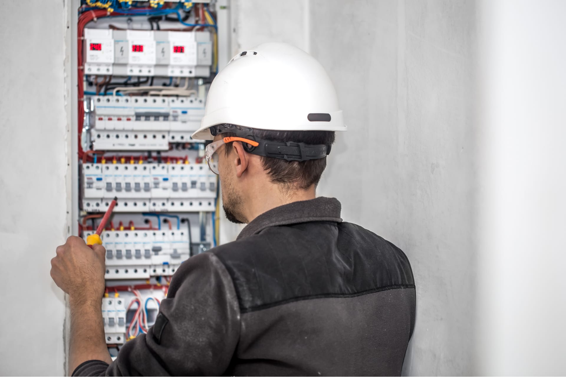 Technician working on an electrical panel