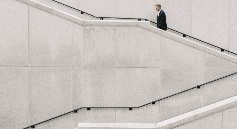 man in suite walking up the stairs