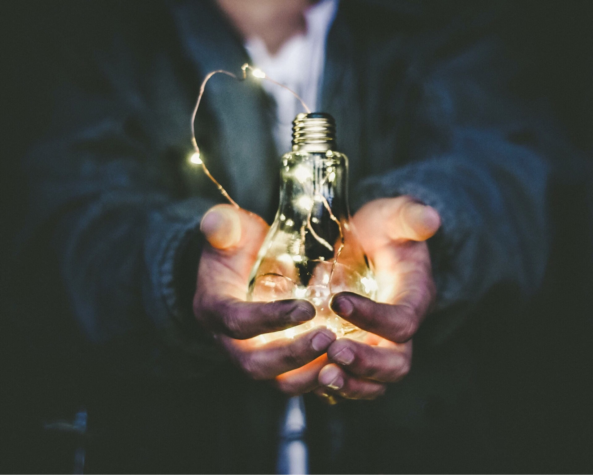 Man holding illuminated light bulb